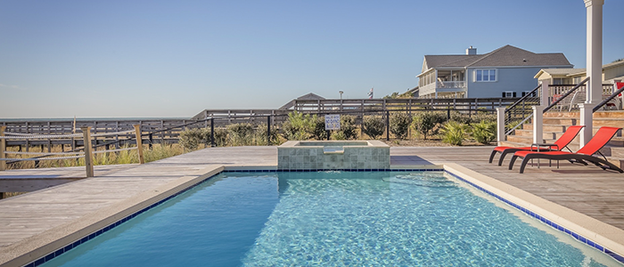 An in-ground pool surrounded by patio